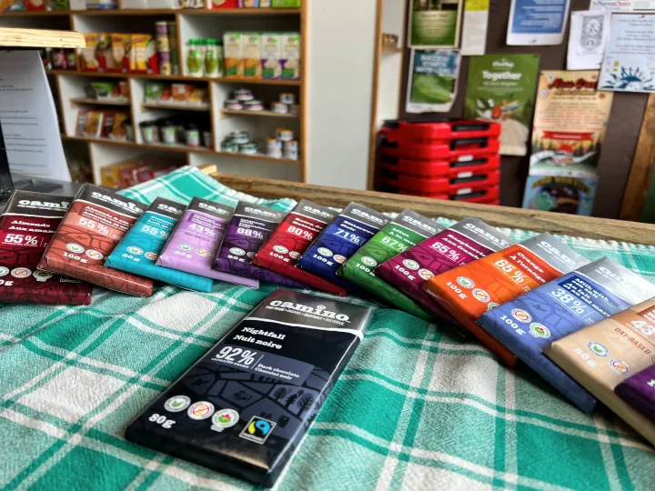 A bunch of Camino chocolate bars spread out onto a counter.