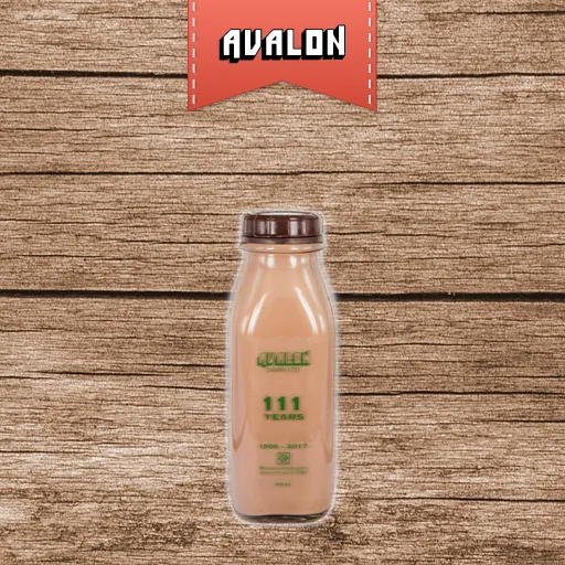 Dark brown cracked wood background with Avalon logo and a glass bottle of chocolate milk