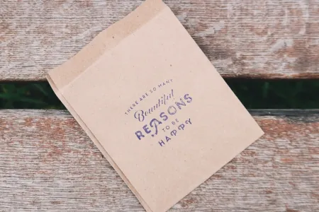 Small brown paper bag on bench by Brigitte Tohm on Pexels