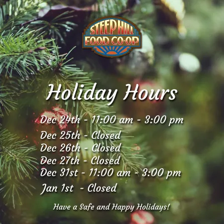 A blurred background of an evergreen tree decorated for Christmas with the the Steep Hill logo on top along with the store holiday hours.