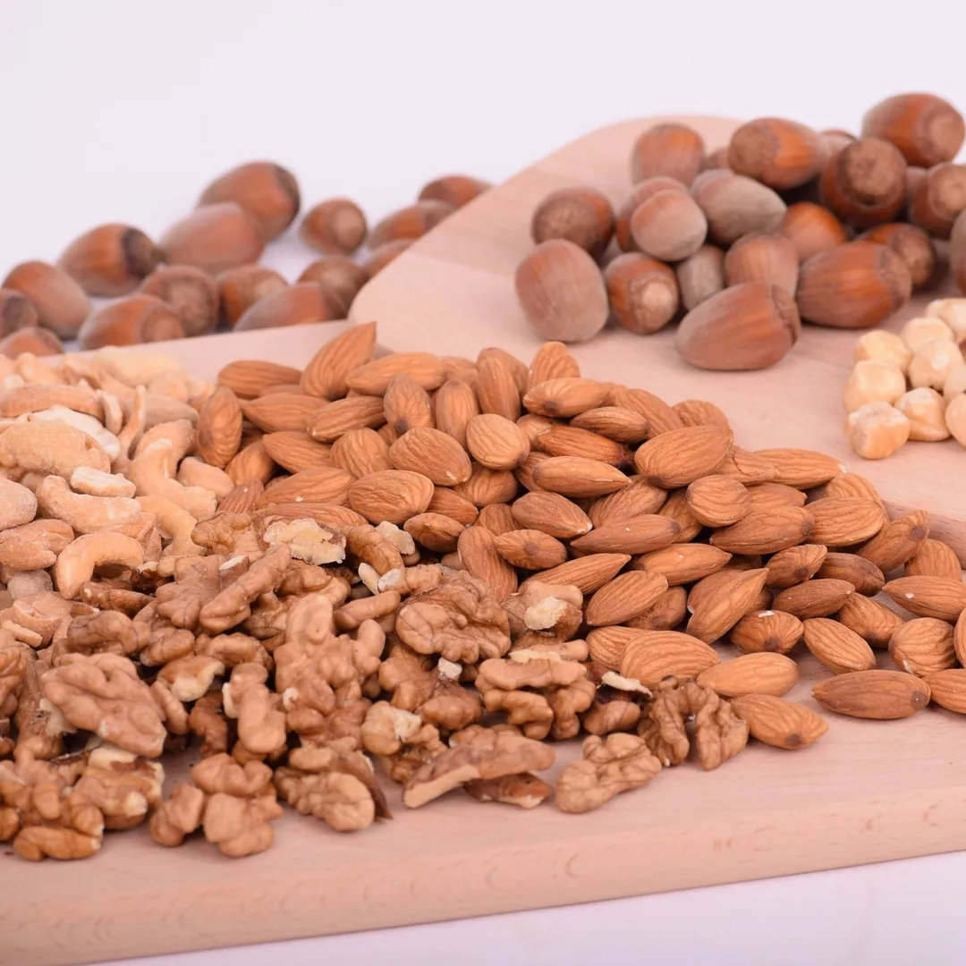 A variety of nuts laid out on cutting boards