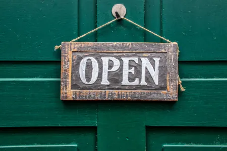 Green wooden door with sign that reads open by analogicus on Pixabay