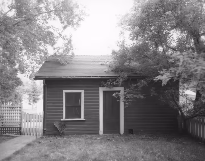 Exterior view of Trounce Residence, now a shed at back of former Lyell Gustin residence, 512 10th Street East. View from backyards.