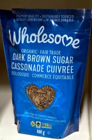 A closeup view of a blue bag of Wholesome organic fair trade dark brown sugar.